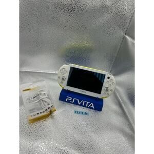 white/yellow with a dash of light blue ps vita 2000 w/charger